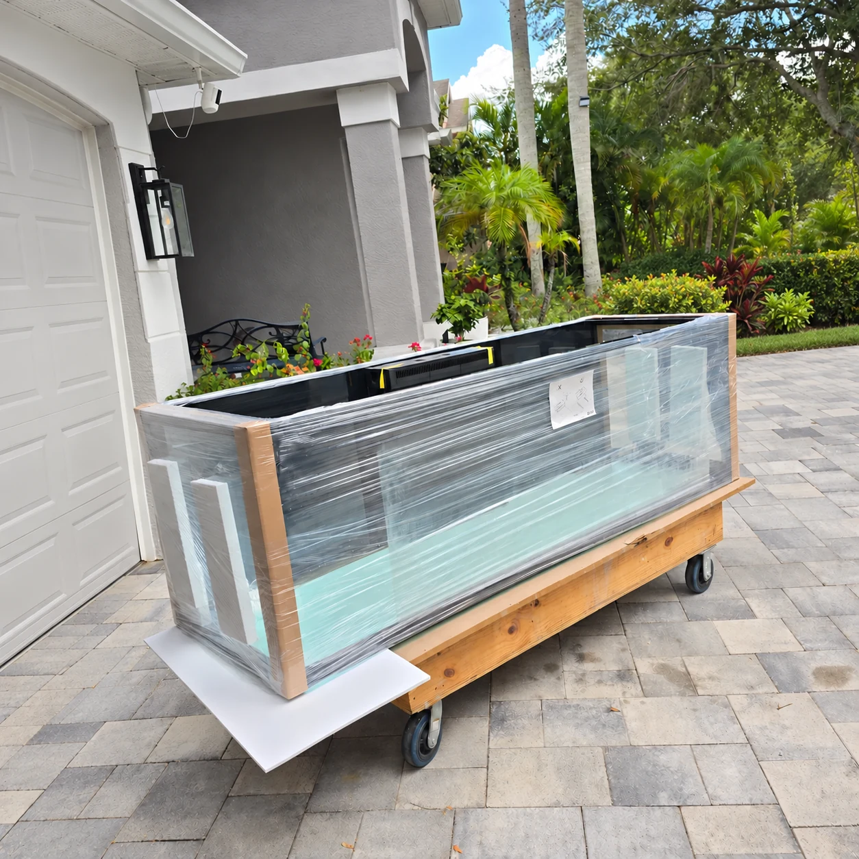 Protected aquarium secured on a moving dolly during relocation